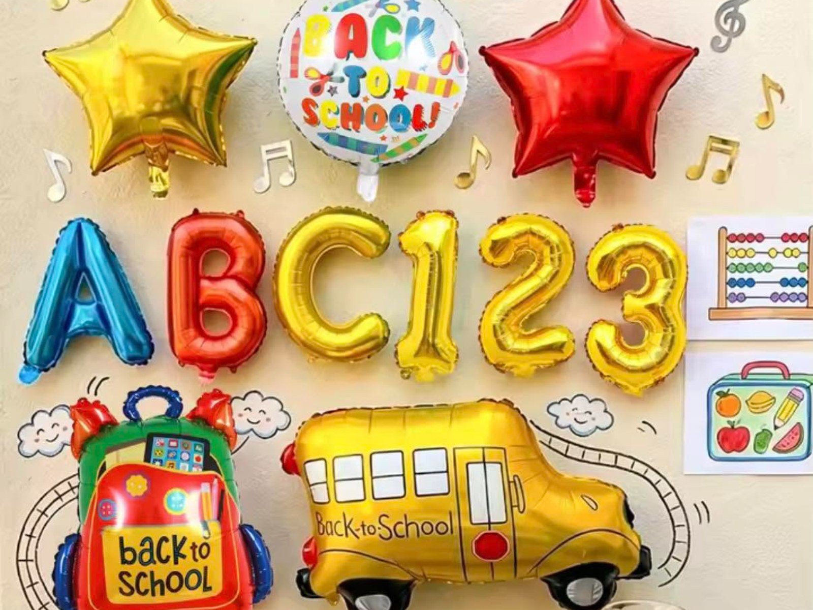Colourful foil balloons with ABC 123 letters, stars and a school bus