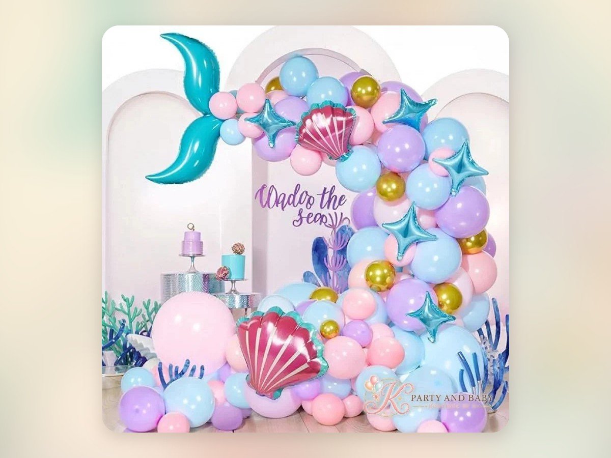 Soft pastel mermaid themed balloon garland with a mermaid tail and shells